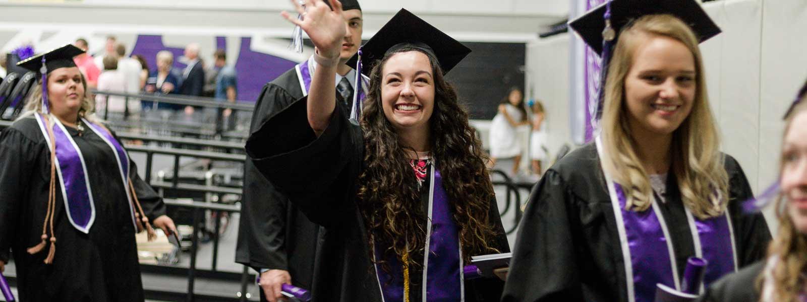 smiling student in commencement processional